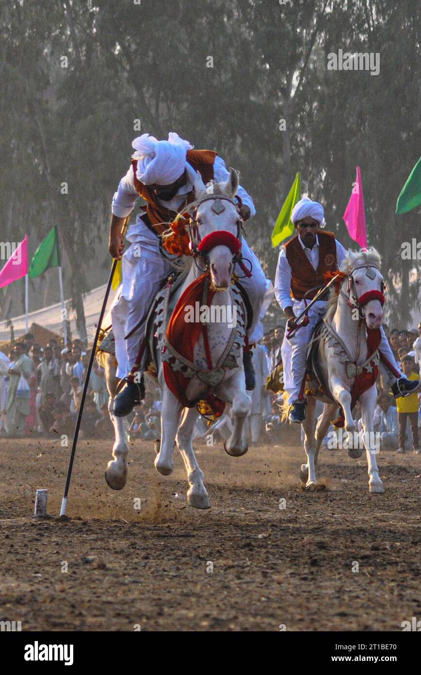 Islamabad, Pakistan. 12th Oct, 2023. Pakistani horsemen charge on a ...