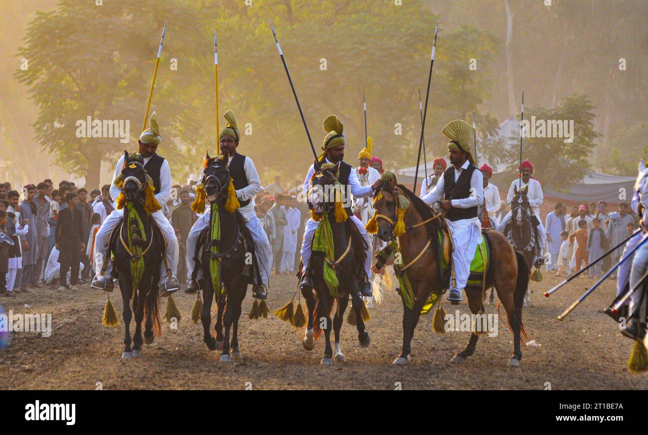 Islamabad, Pakistan. 12th Oct, 2023. Pakistani horsemen charge on a ...