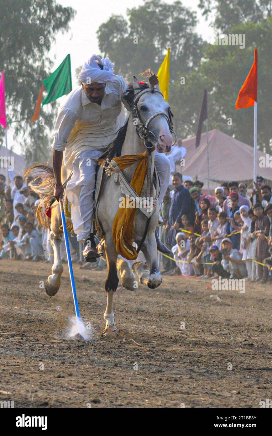 Islamabad, Pakistan. 12th Oct, 2023. Pakistani horsemen charge on a ...