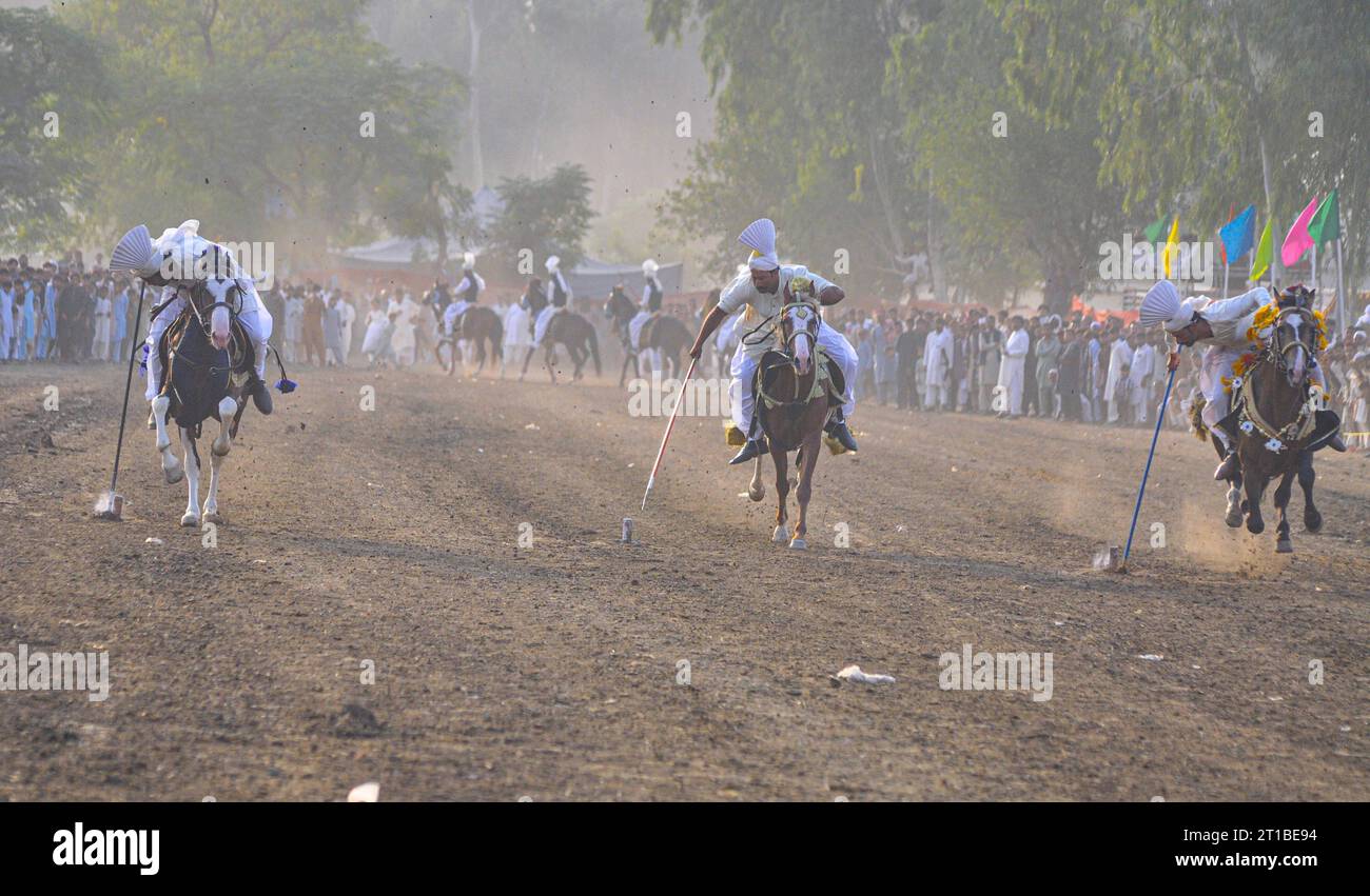 Islamabad, Pakistan. 12th Oct, 2023. Pakistani horsemen charge on a ...