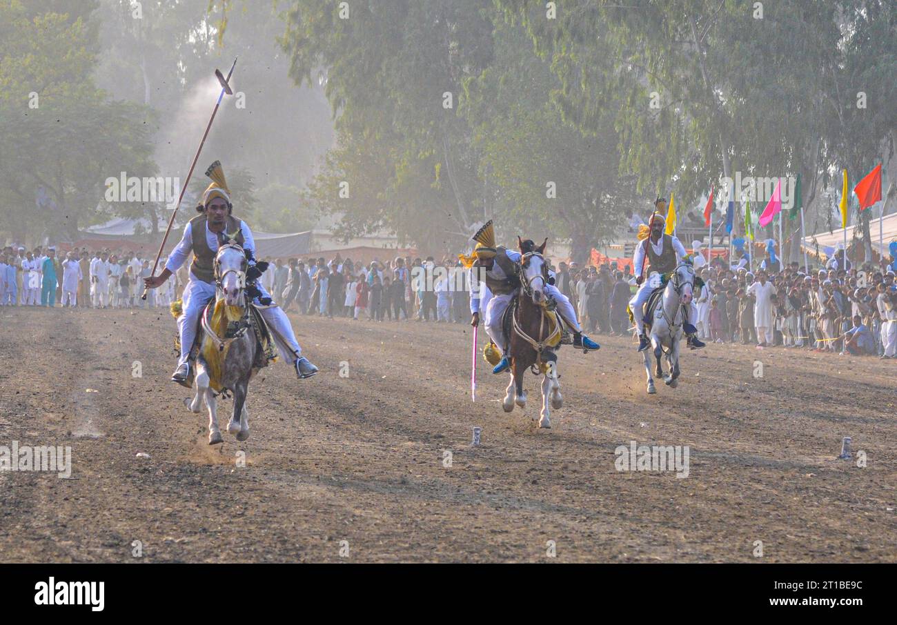 Islamabad, Pakistan. 12th Oct, 2023. Pakistani horsemen charge on a ...