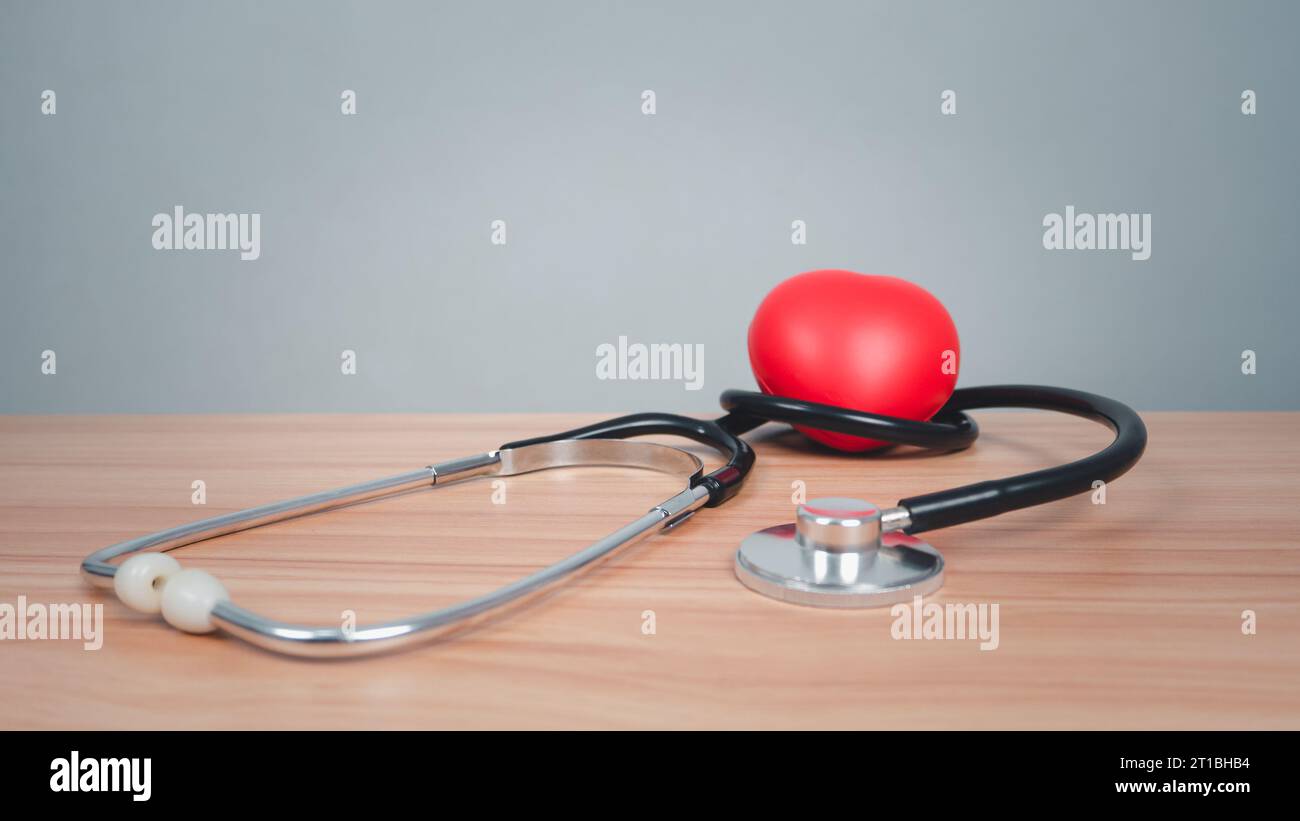 https://c8.alamy.com/comp/2T1BHB4/red-heart-with-headphones-on-a-wooden-table-background-medical-and-healthcare-concepts-2T1BHB4.jpg