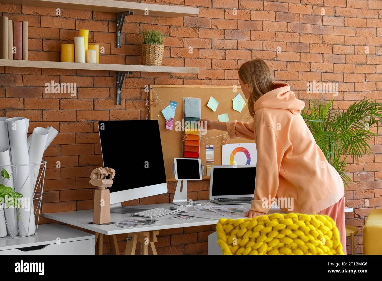Female fashion designer working in office Stock Photo - Alamy