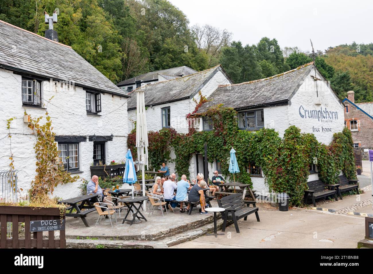 The Crumplehorn Inn & Mill in Polperro village,Cornwall,England,UK taken September 2023, people sitting outside drinking and eating Stock Photo