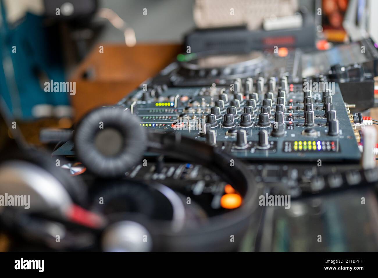 DJ console. Amplifying equipment, studio audio mixer knobs and faders. Music production, creation. Stock Photo