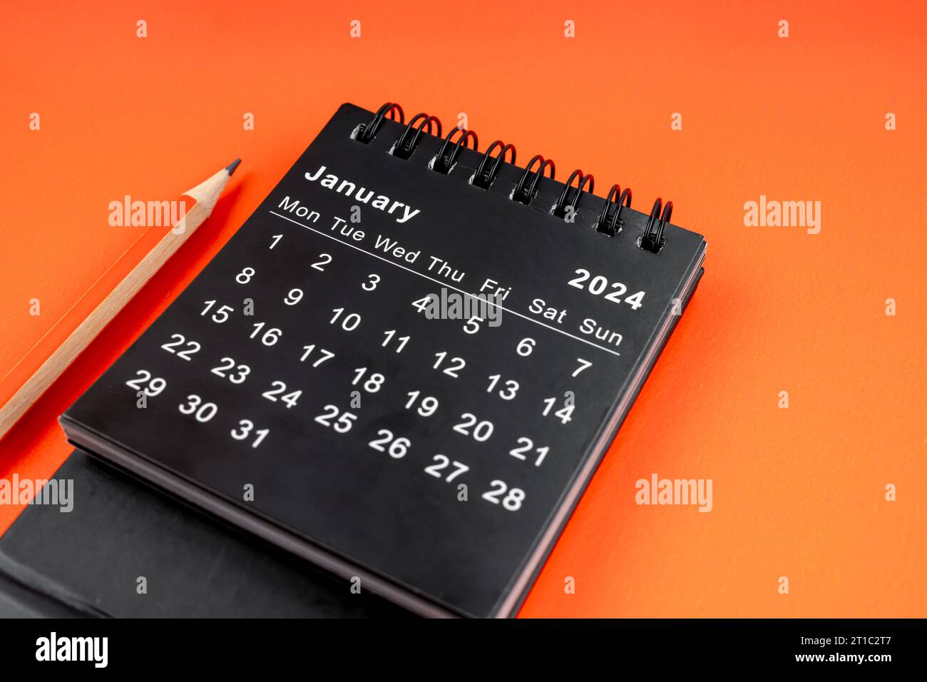 January 2024 desk calendar with pencil on orange color background Stock ...