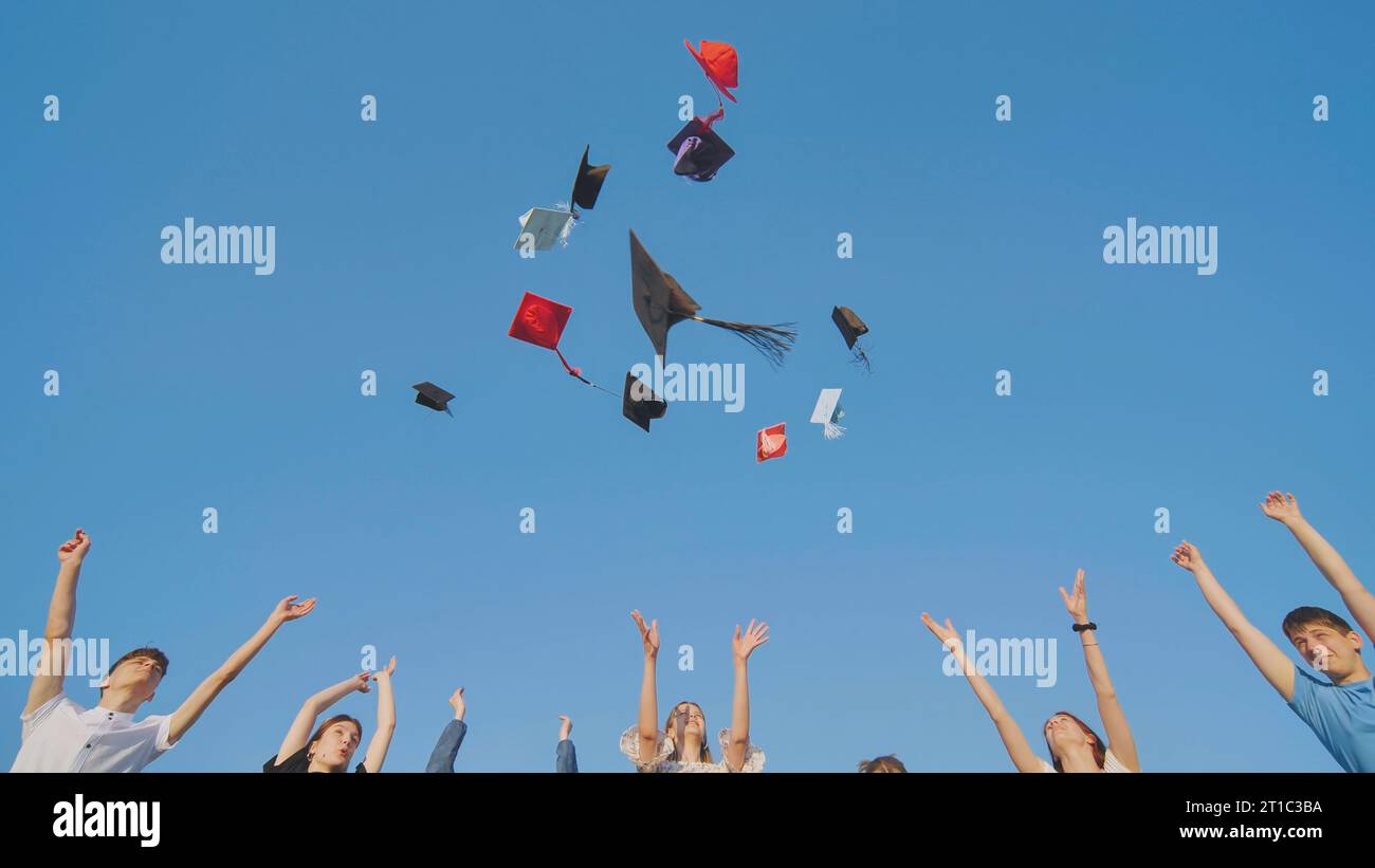 College graduates throw colorful hats up in the air Stock Photo Alamy