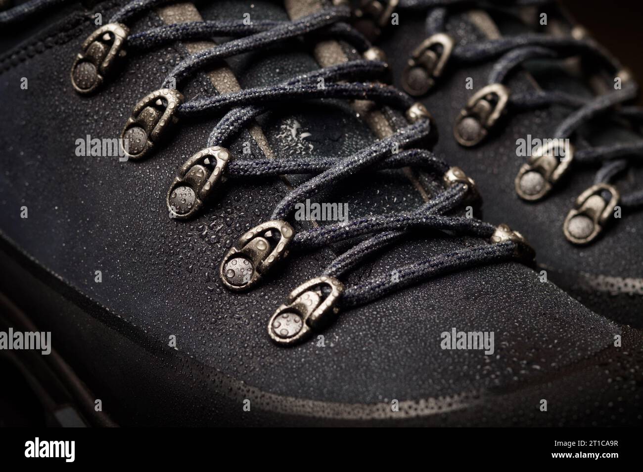 Tourist boots for mountain hikes with reinforced soles and membrane material. raindrops on the surface Stock Photo
