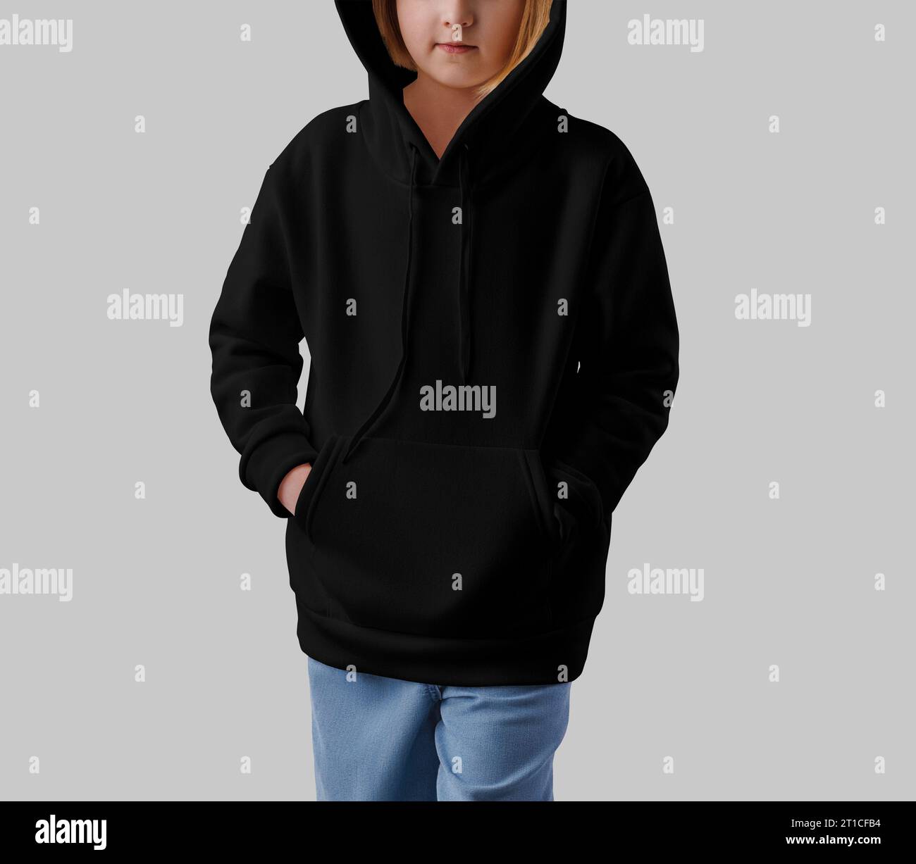 Mockup of a black hoodie on a hooded girl, front view, isolated on background. Template of stylish children's clothing for design, branding. Fashionab Stock Photo