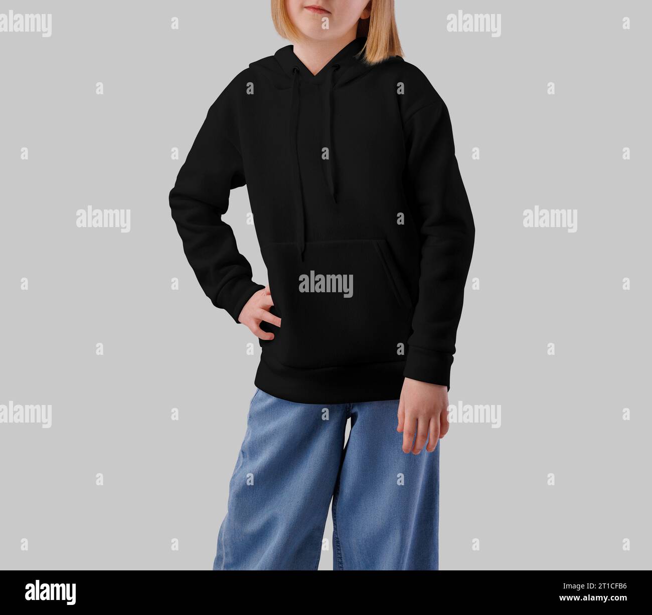 Mockup of a black hoodie on a posing girl, front view, isolated on the background. Product photography. Warm streetwear, children's sweatshirt. Casual Stock Photo
