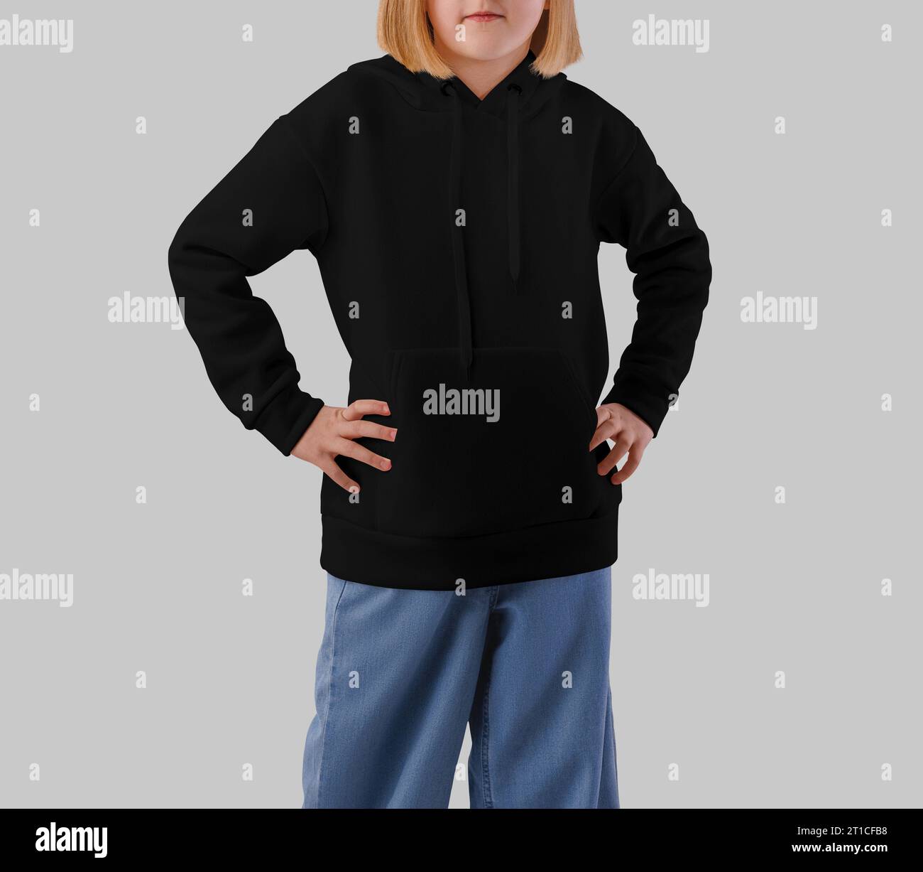 Template of a black hoodie on a posing girl, front view, shirt for design, branding. Mockup of textured kid's clothing, isolated on the background. Pr Stock Photo