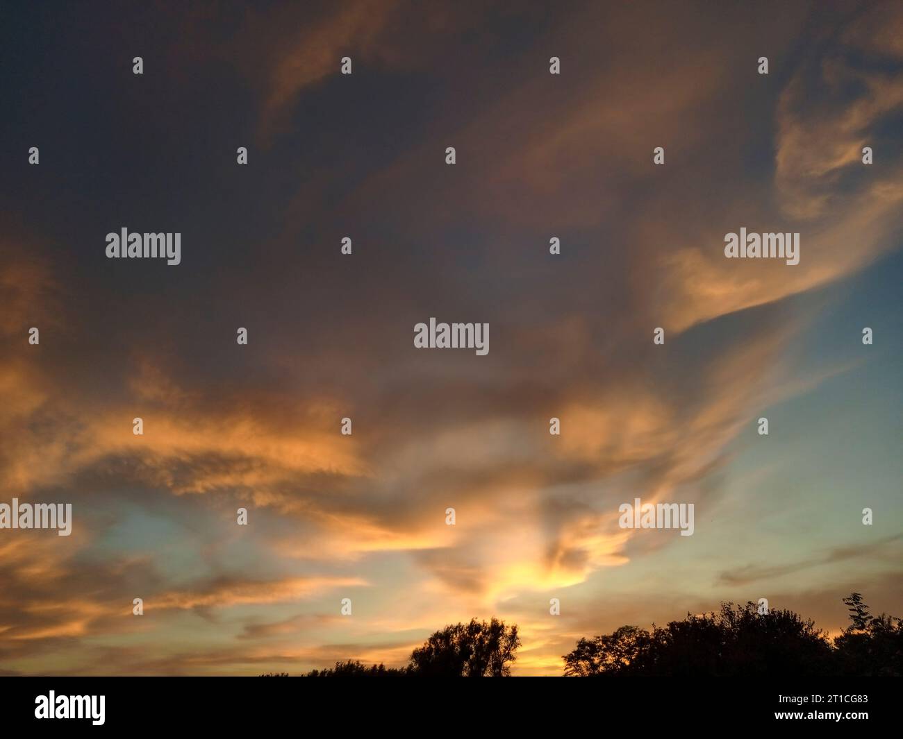 Abstract sky with orange clouds glowing from the sunset Stock Photo - Alamy