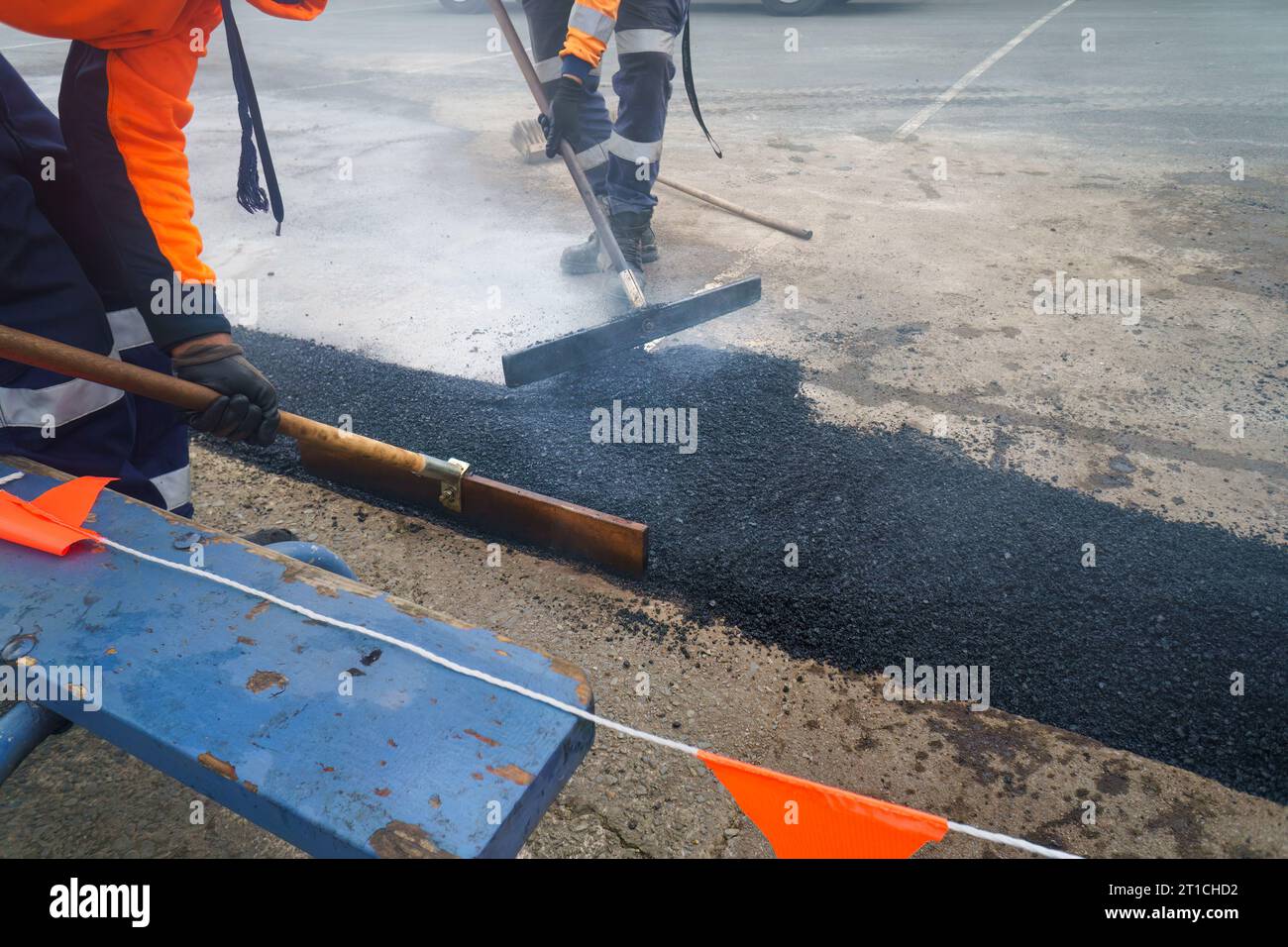 Road resurfacing. Fresh asphalt construction. Workers repairing the road. Auckland. Stock Photo