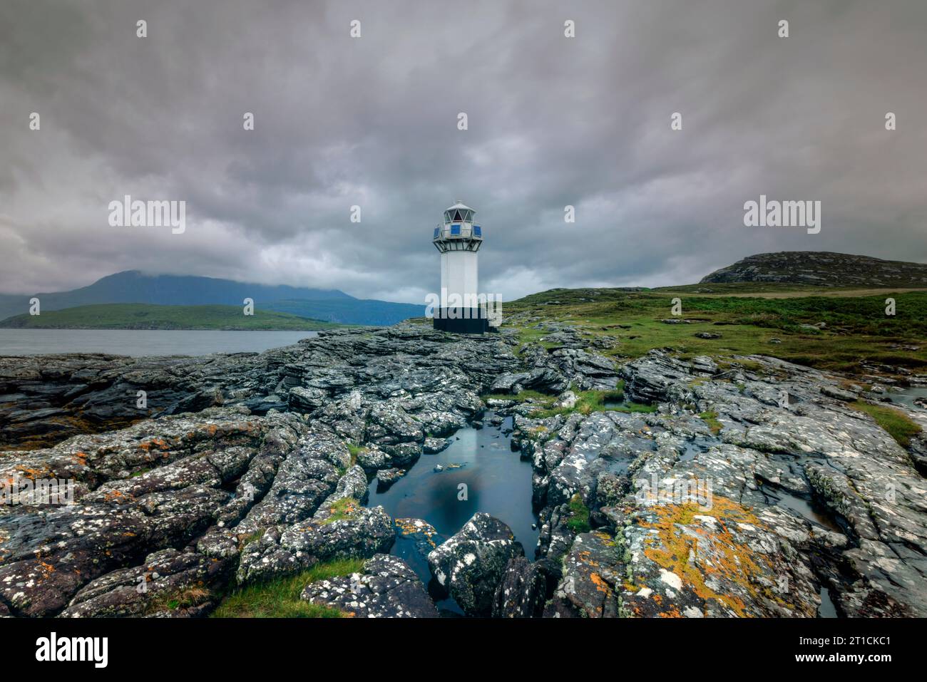 Rhue Lighthouse is a white lighthouse located on the coast of Loch Broom, near Ullapool, Scotland. Stock Photo