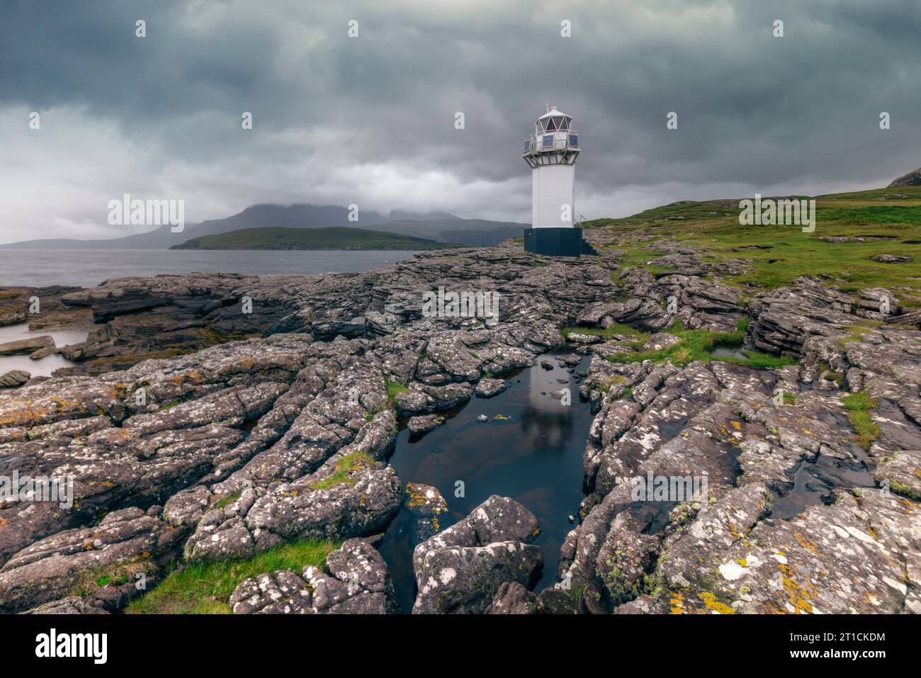 Rhue Lighthouse is a white lighthouse located on the coast of Loch Broom, near Ullapool, Scotland. Stock Photo