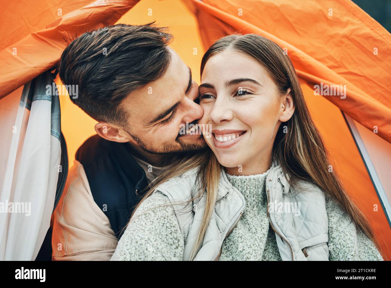 Happy Couple Kiss And Tent For Camping Holiday Or Outdoor Vacation Together In Affection