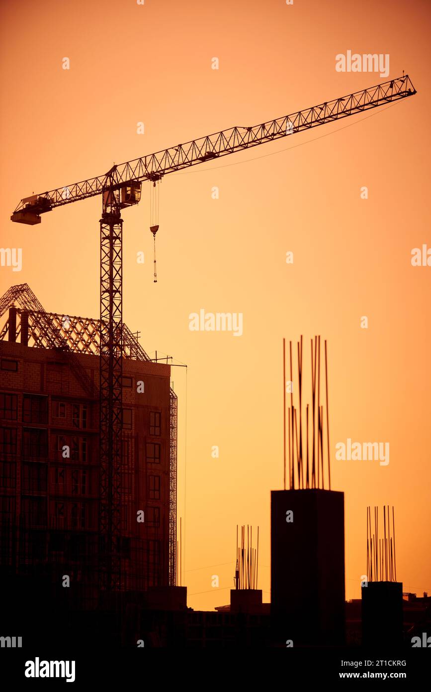 Silhouette of the tower crane on the construction site with city ...