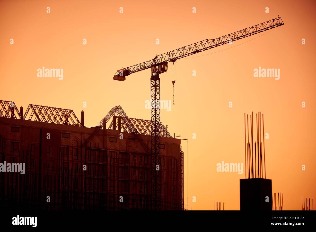 Silhouette of the tower crane on the construction site with city ...