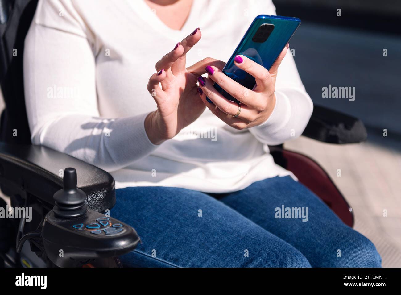 woman using wheelchair using mobile phone Stock Photo