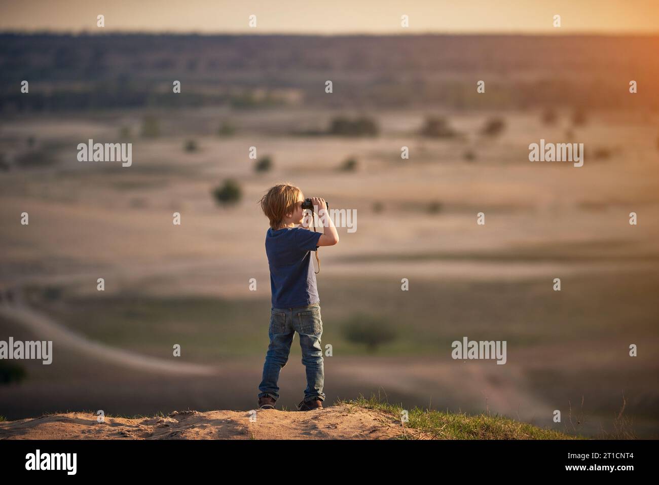 Boy Looking through Binoculars outdoors at sunny day Stock Photo - Alamy