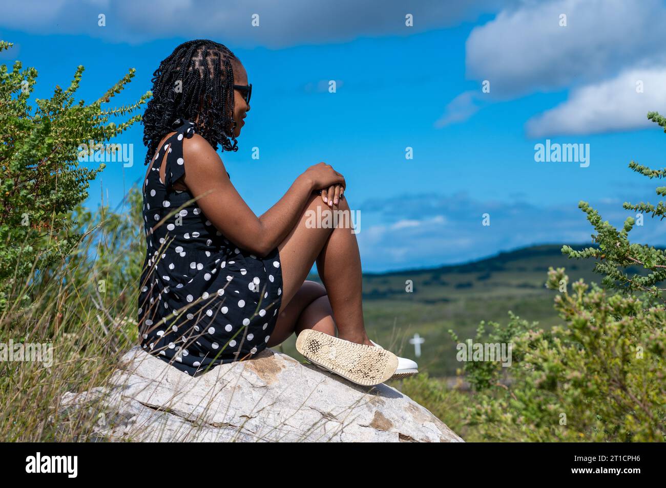 Beautiful woman sitting on rock hi-res stock photography and images - Alamy