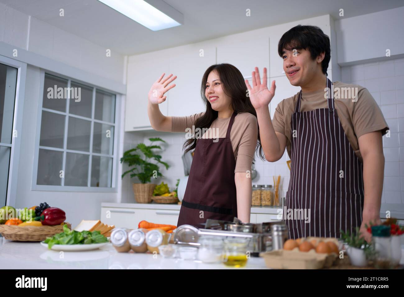 Young couple is cooking in kitchen. Lifestyle and leisure activity concept. Stock Photo