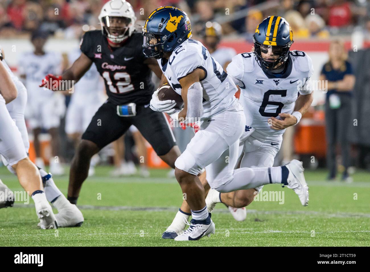 Houston, TX, USA. 12th Oct, 2023. West Virginia Mountaineers running back Jahiem White (22) carries the ball after receiving the handoff from quarterback Garrett Greene (6) during a game between the West Virginia Mountaineers and the Houston Cougars in Houston, TX. Trask Smith/CSM (Credit Image: © Trask Smith/Cal Sport Media). Credit: csm/Alamy Live News Stock Photo