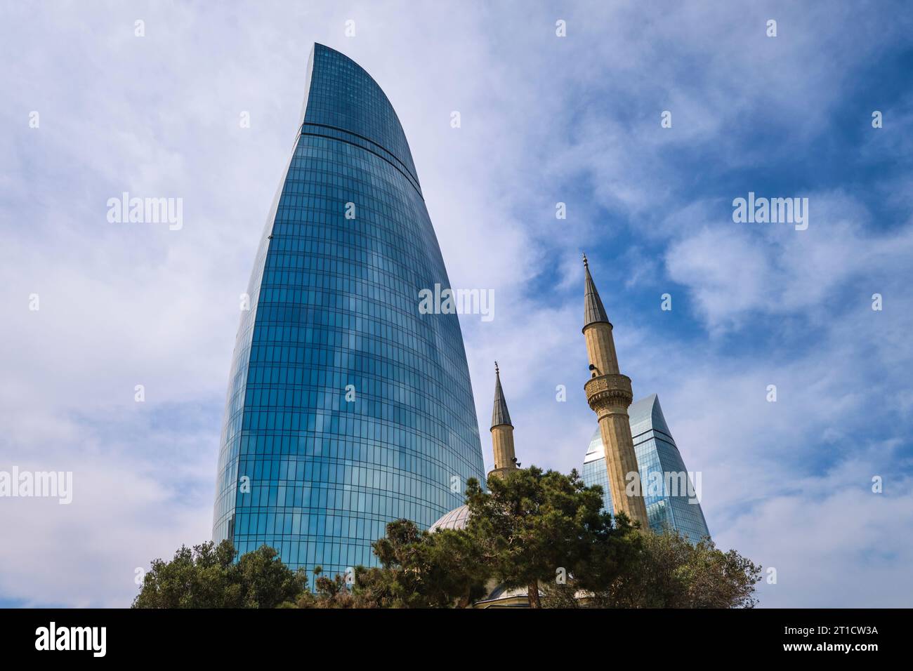 At the iconic, modern, blue glass Flame Towers, designed by HOK. The Alley of Martyrs Mosque in the foreground. In Baku, Azerbaijan. Stock Photo