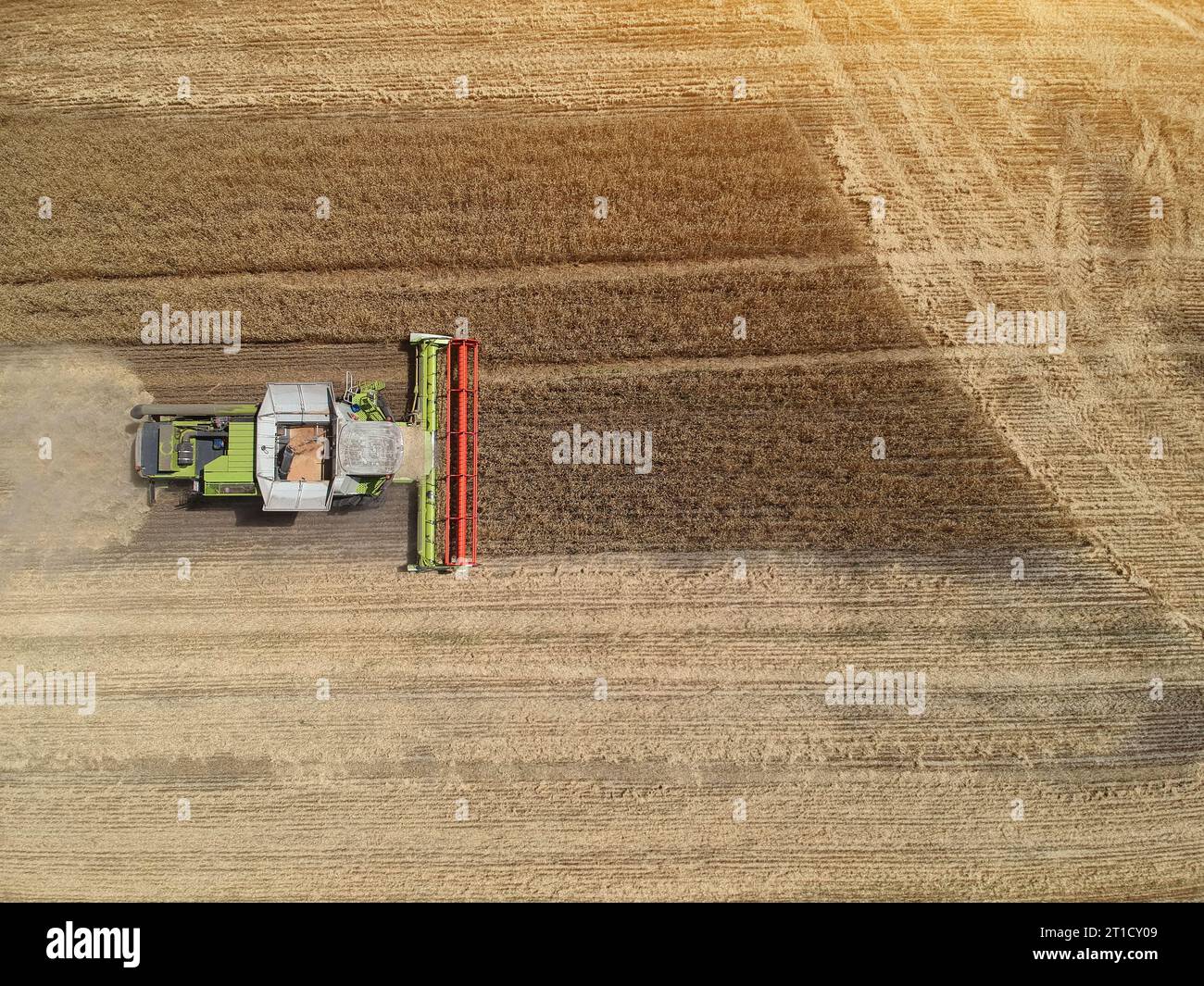 Aerial View of a combine harvester working in the fields. Drone photo ...