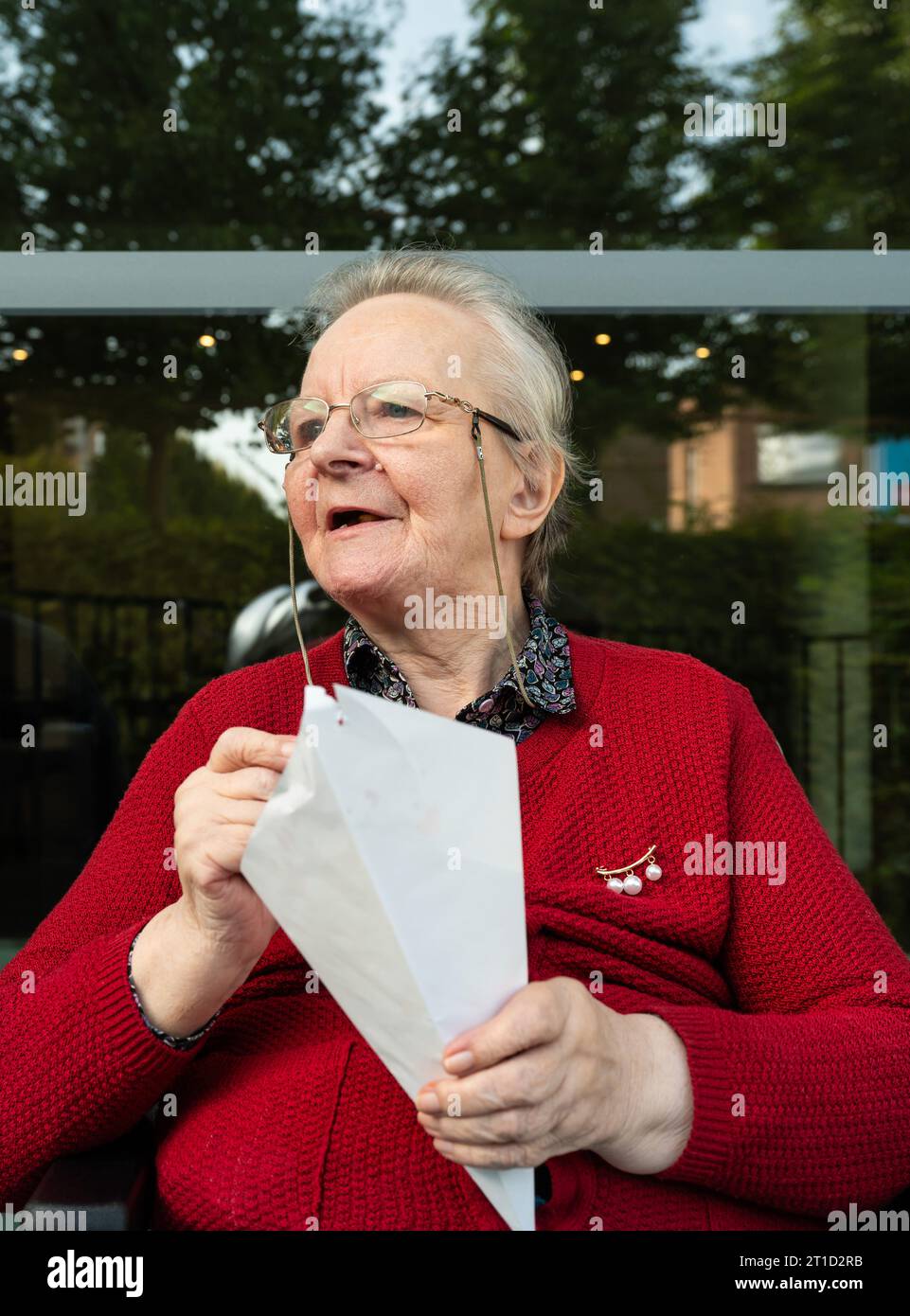 Portrait of a 85 yo woman eating French Fries, Tienen, Flanders, Belgium Stock Photo