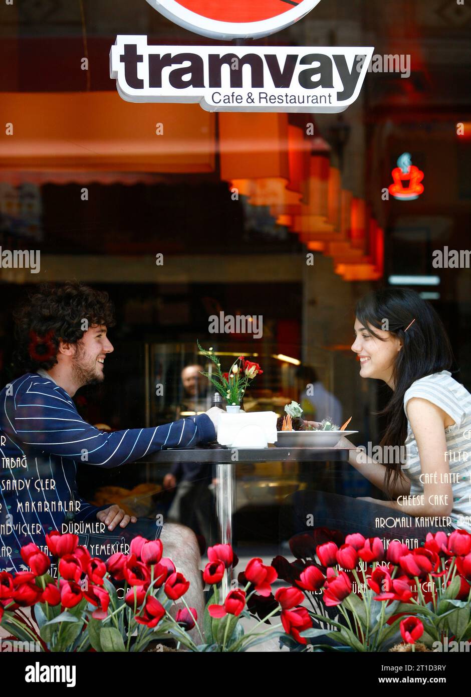 Couple sitting at a trendy cafe in the Istiklal pedestrian street in Beyoglu area. Istanbul, Turkey. Stock Photo