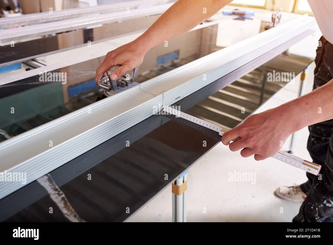 Construction worker cutting ceramic tiles using ceramic cutter Stock Photo