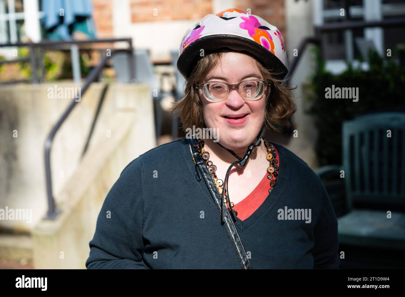 Outdoor portrait of a 41 yo woman with the Down Syndrome, wearing a