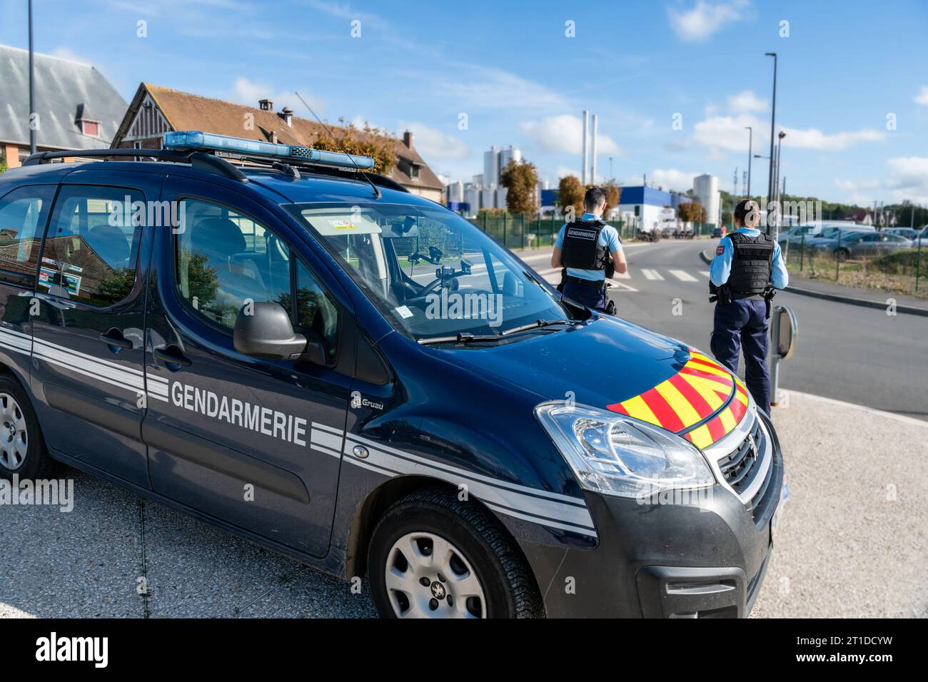 Police officers (“gendarmes”) carrying out a roadside check at a traffic circle Stock Photo
