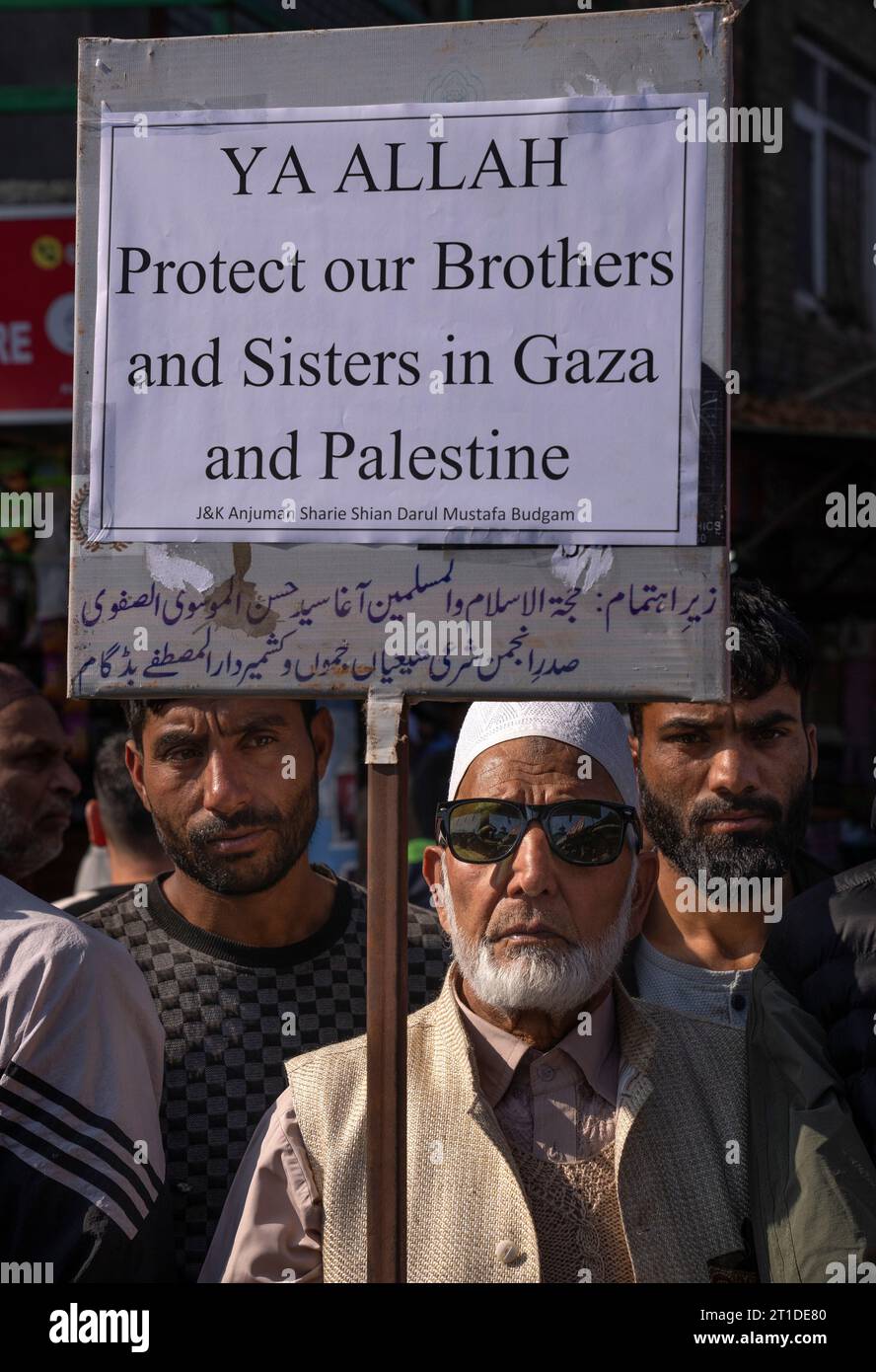 An elderly Kashmiri Shiite Muslim holds a placard during a protest ...