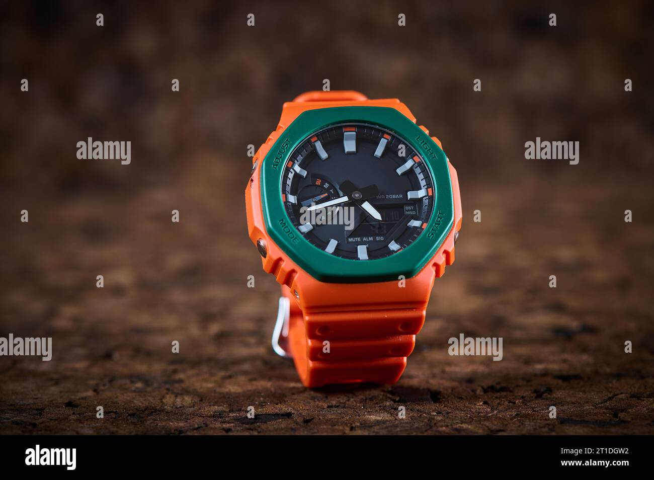 Orange bright wrist watch on wooden background closeup Stock Photo