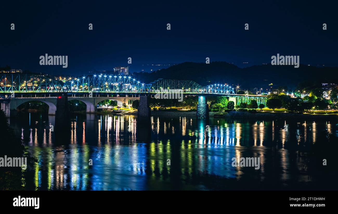 A stunning nightscape featuring a city skyline reflected in the still ...