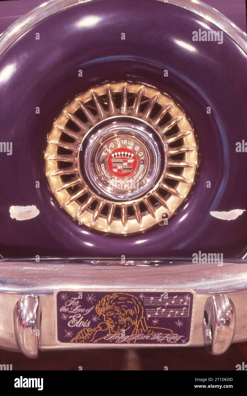 The rear Elvis' first Cadillac - a 1956 Caddy - on display at a memorabilia show in Memphis in 1978. The show coincided with Elvis birthday, the first after his passing. In Memphis, Tennessee. there's some glare from the overhead lights but the two horizontal white shapes appear to be scratches. Stock Photo