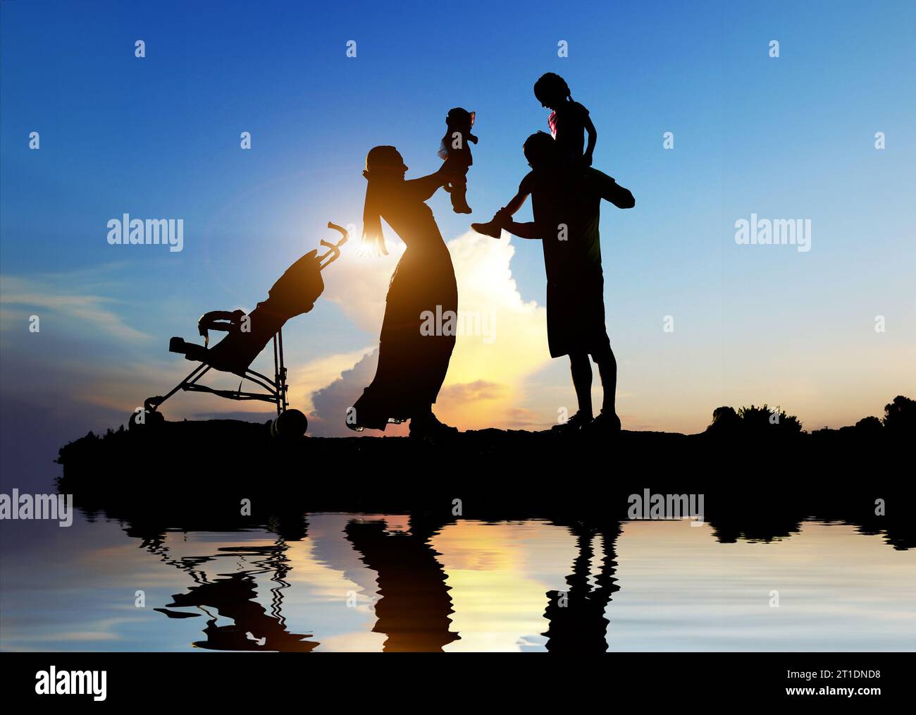 Silhouettes of happy parents having good time with their little ...