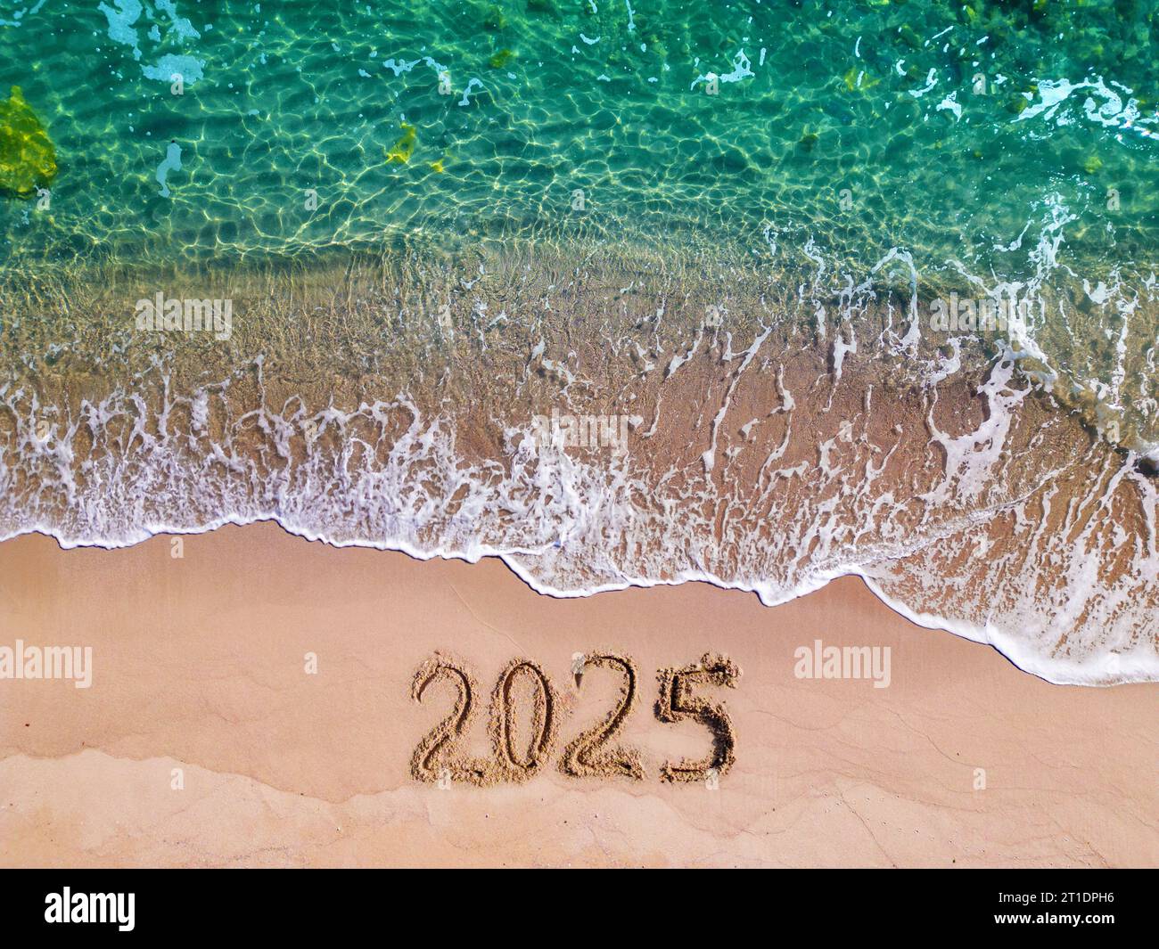 2025 year written on sandy beach sea at sunny day Stock Photo Alamy