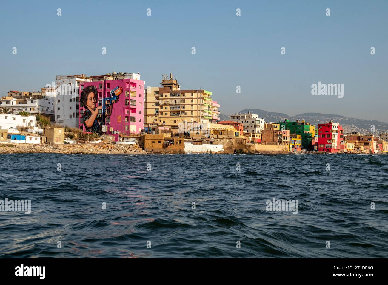 Beirut, Lebanon - 7 24 2018: The colorful buildings of the Ouzai Ouzville slums neighborhood south of Beirut, Lebanon. The buildings are prominently v Stock Photo