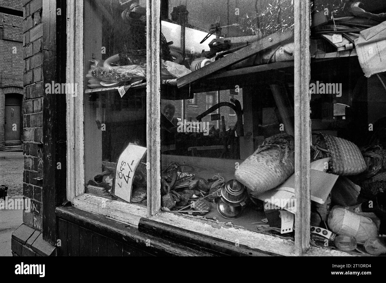Second-hand shop window on the corner of Pym Street and Flewitt Street, during the slum clearance and demolition of St Ann's, Nottingham. 1969-1972 Stock Photo