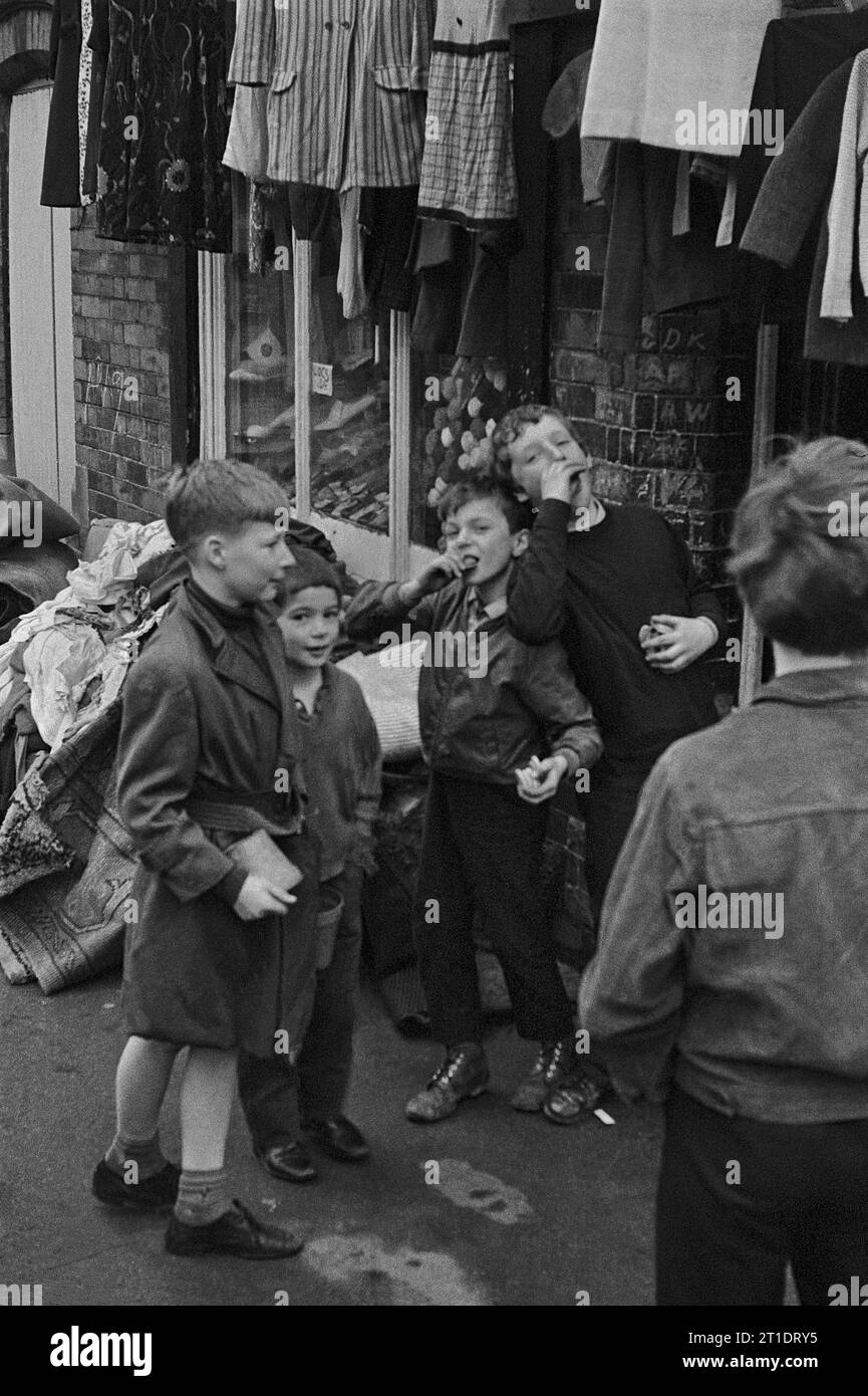 Group of boys playing outside a junk shop on the corner of Pym Street, Flewitt Street during the slum clearance of St Ann's, Nottingham. 1969-1972 Stock Photo