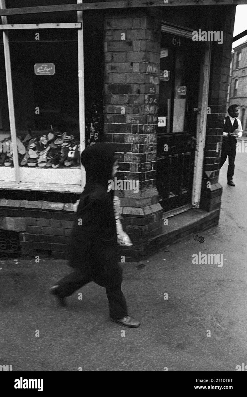 Boy returning from a shopping errand to a shop on the corner of  Pym Street, Flewitt Street during the slum clearance of St Ann's, Nottingham. 1969-72 Stock Photo