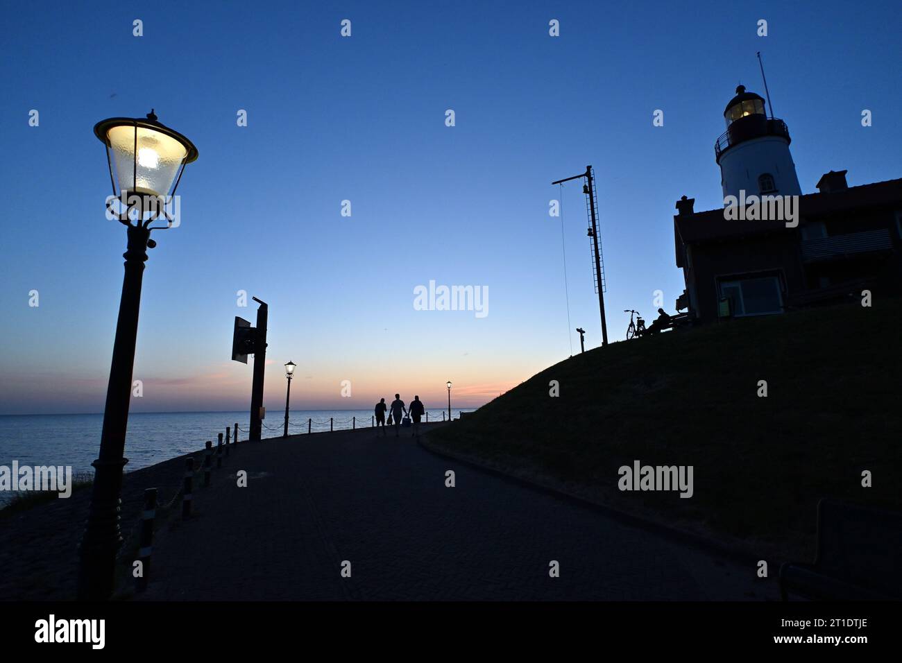 Lighthouse with sunset, Urk on the IJsselmeer, Netherlands Stock Photo