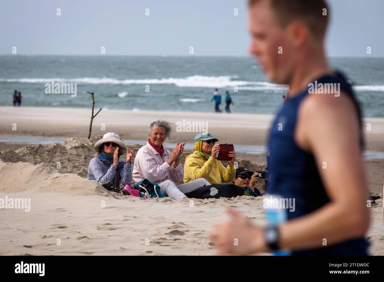 spectators of the Coast Marathon Zeeland on the beach in Oostkapelle on ...
