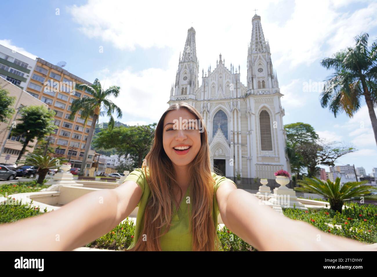 Selfie girl in Vitoria, Brazil. Young tourist woman taking self portrait with Vitoria Cathedral, Espirito Santo, Brazil. Stock Photo