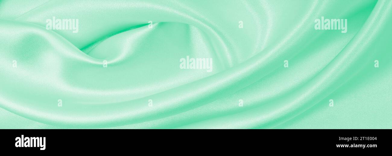 Smooth elegant green silk or satin luxury cloth texture can use as ...
