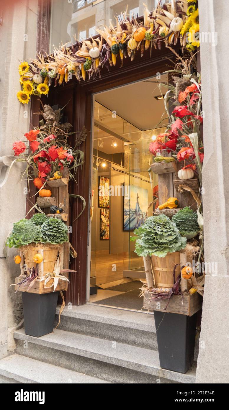 store front with elaborate fall harvest décor around entrance on St