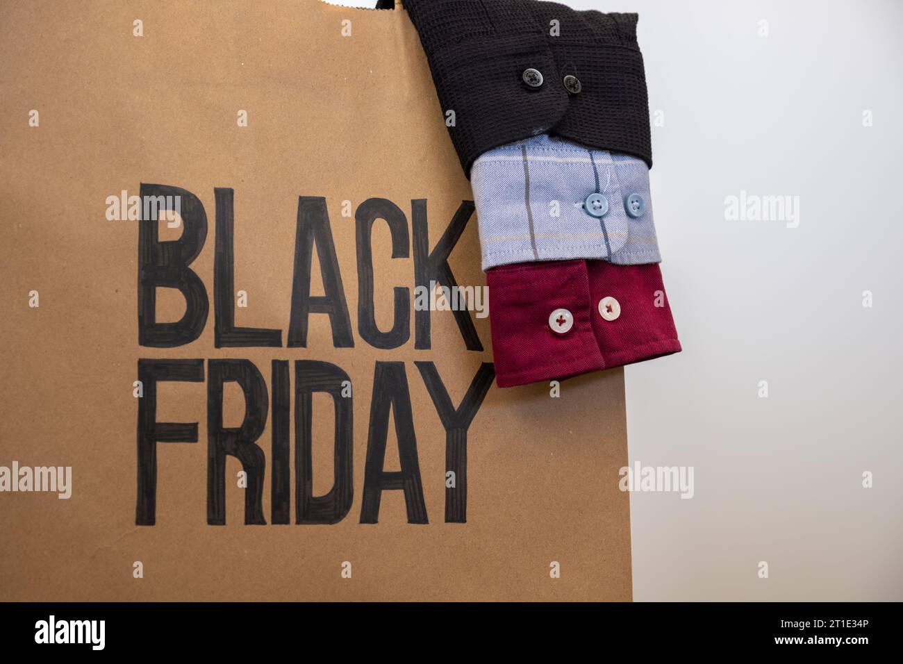 Shirt sleeve with shopping bag represents clothes sales for black friday and white friday with mock up space or free space Stock Photo